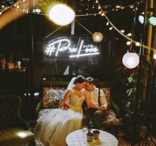 White LED neon hashtag sign above a wedding couple