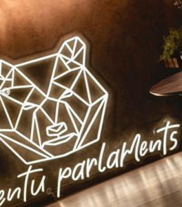 White geometric bear head LED neon sign in a bar