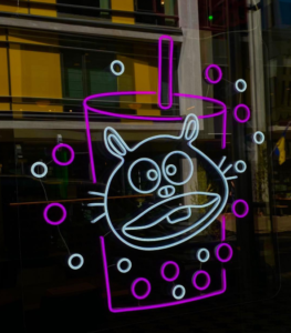 LED neon sign with a hamster in a bubble tea cup in a shop window