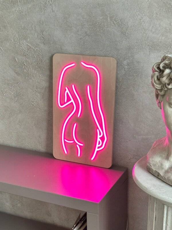Pink body line-art LED neon sign on a wooden backboard