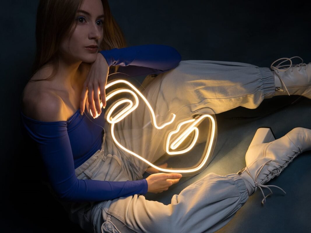 Model posing with a warm white female portrait LED neon sign