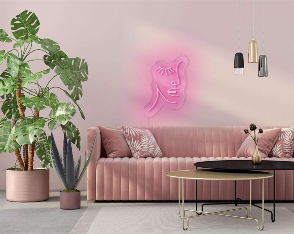 Pink face with eyelashes line-art LED neon sign above a pink sofa