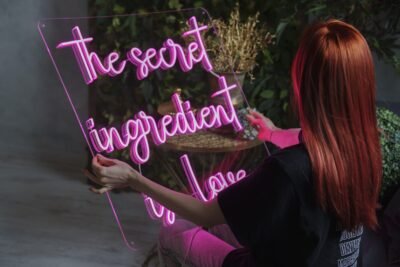 Pink LED neon sign "the secret ingredient is love" on clear acrylic