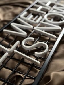 White LED neon letters mounted on a black metal grid backing