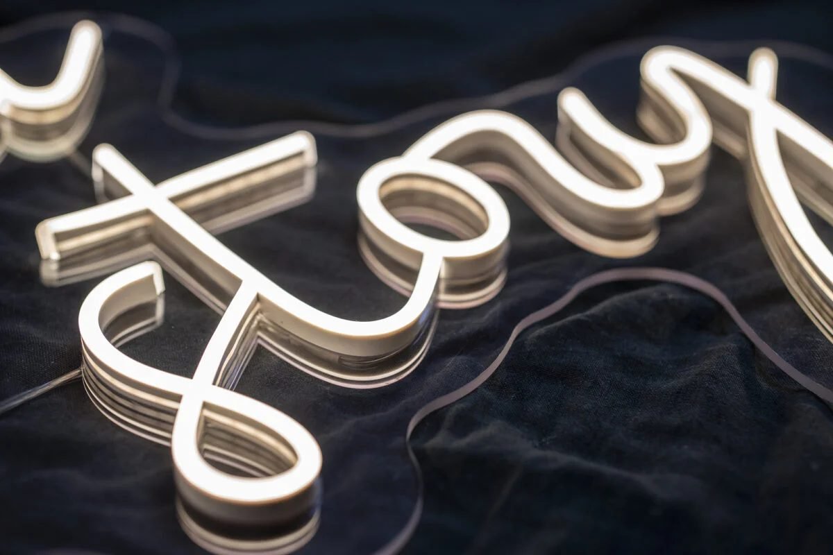 Close-up of warm white neon lettering