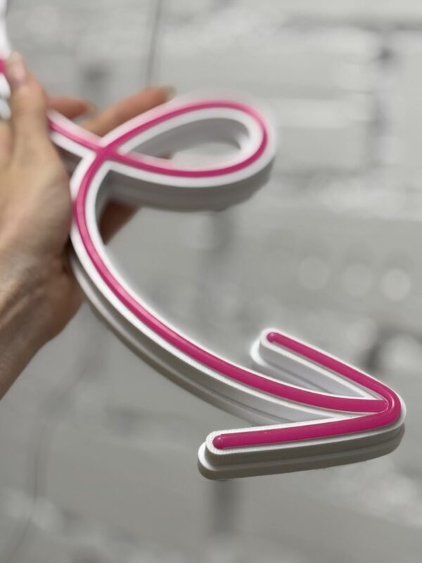 Pink LED neon line held in a hand